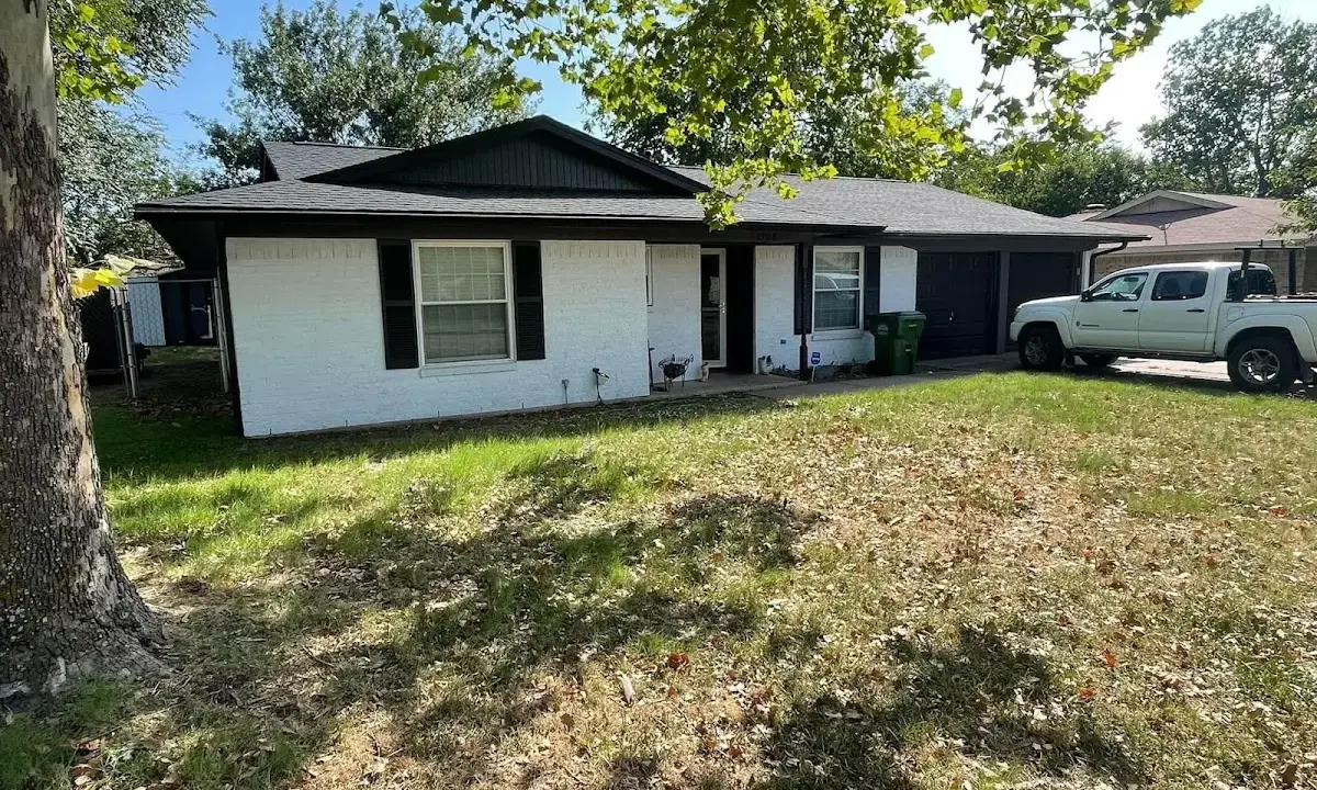 Professional roofing crew working on a residential roof in Norwell